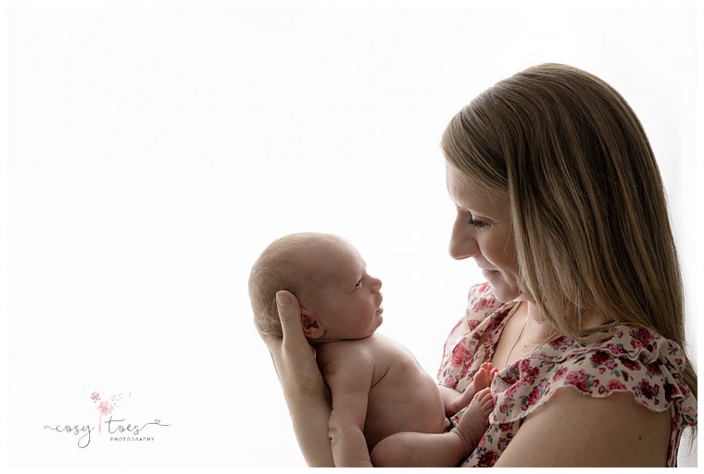 sweet moment between mum with her newborn baby