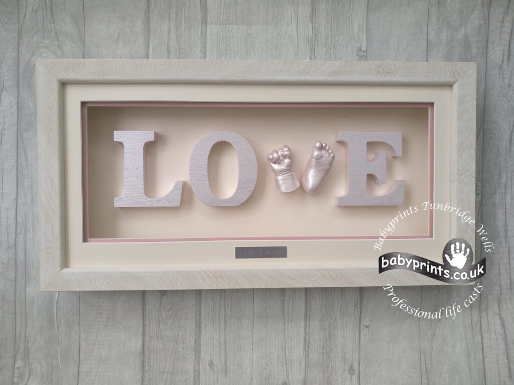 Baby Prints Tunbridge Wells baby hand and foot casting in a natural frame spelling out the word LOVE