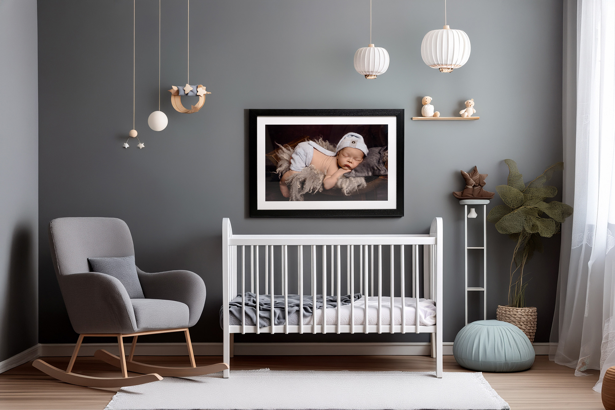 A baby's nursery with a beautiful photo of a baby above the cot.