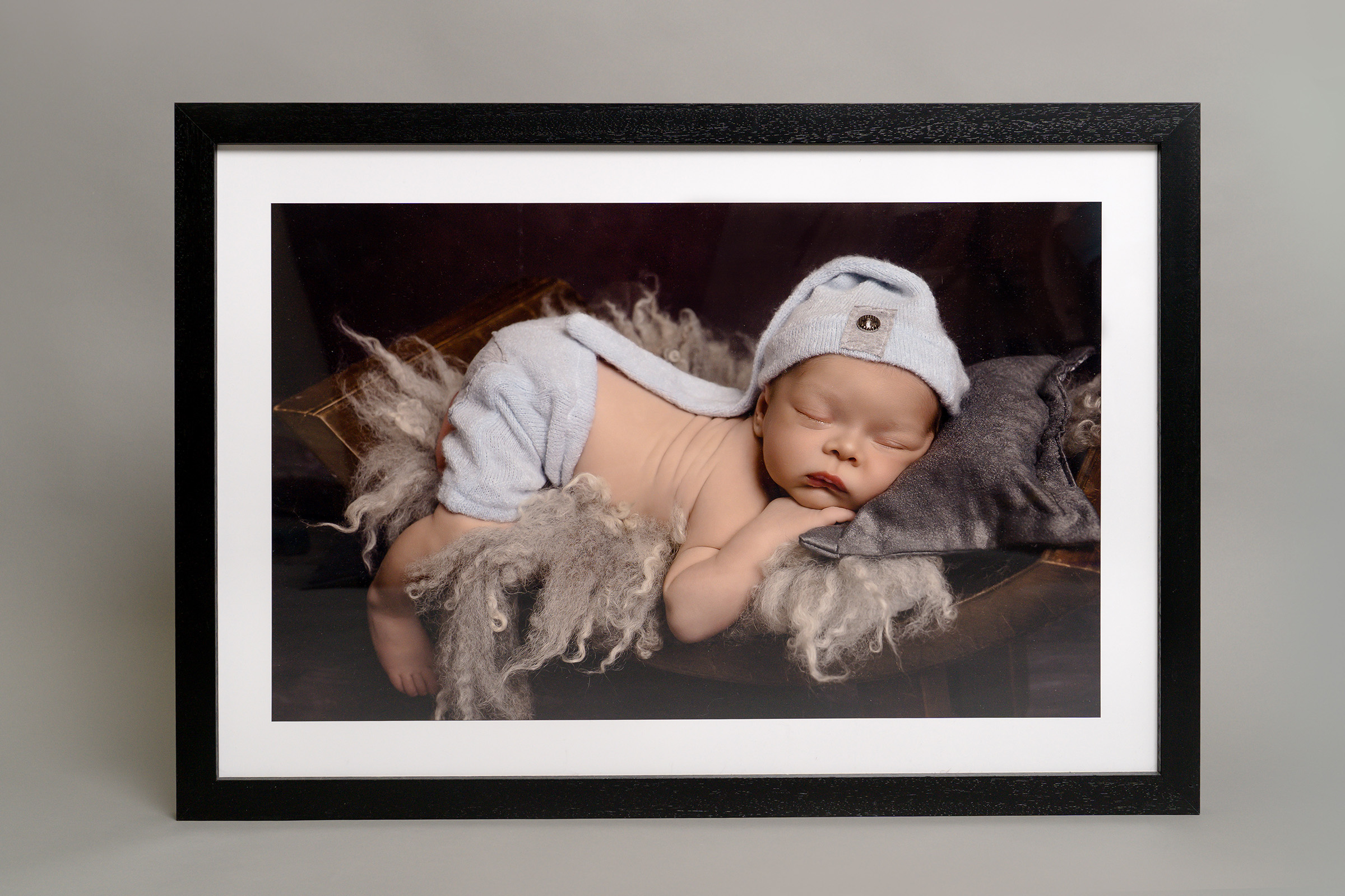 An elegant simple wall art frame of a baby sleeping peacefully