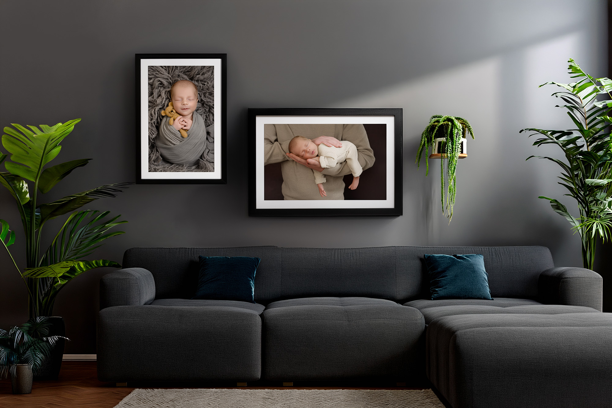 A living room decorated in grey with two beautiful wall art frames of a baby above the sofa